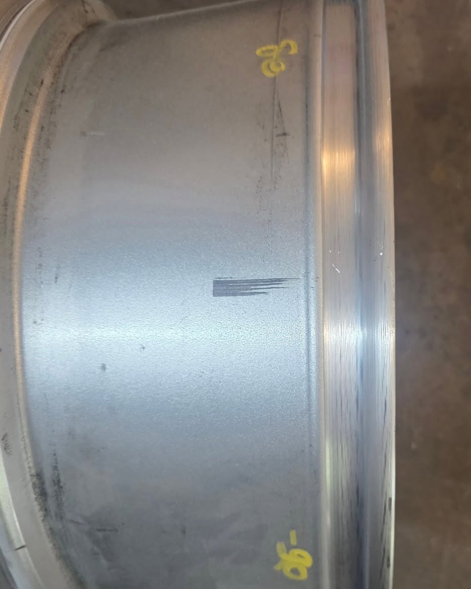 Silver alloy wheel barrel with scratches — before restoration