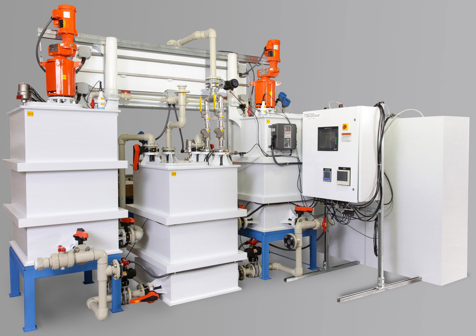 Large white multi-tank industrial processing system with orange motors