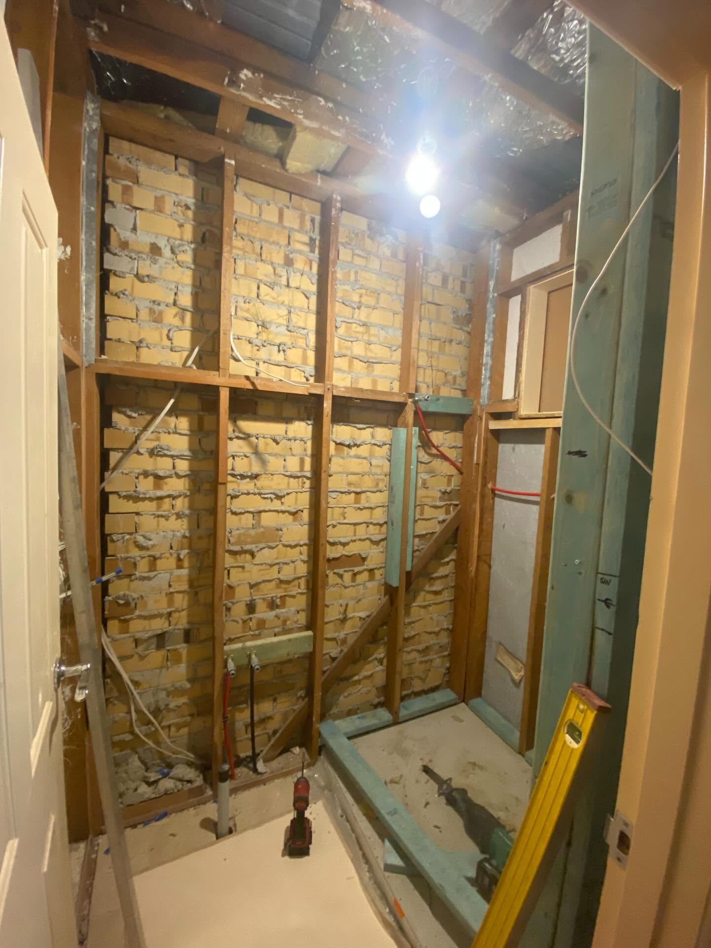 Internal remodelling in progress — exposed brick and timber framing