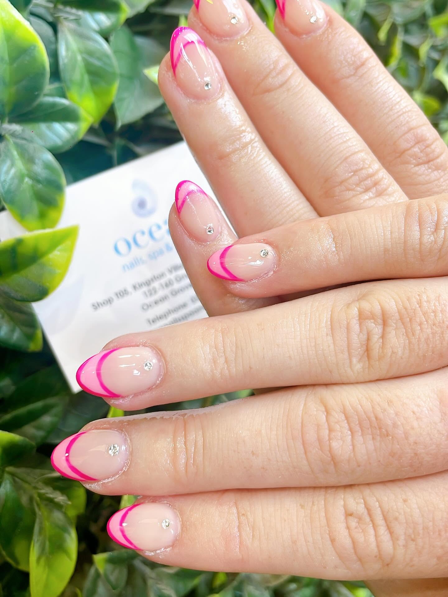 Hot pink French tip nails with silver rhinestones