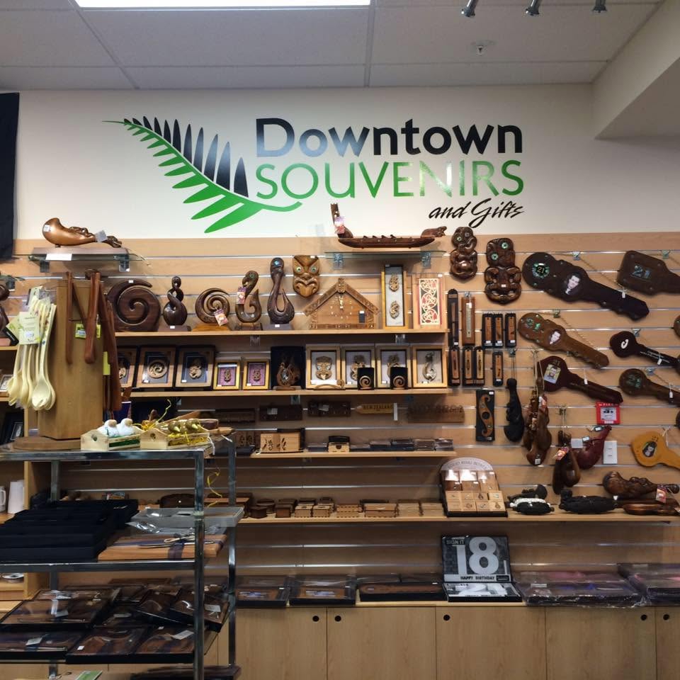 Wall display of Aboriginal and Maori carved wooden crafts and decorative artworks inside the store