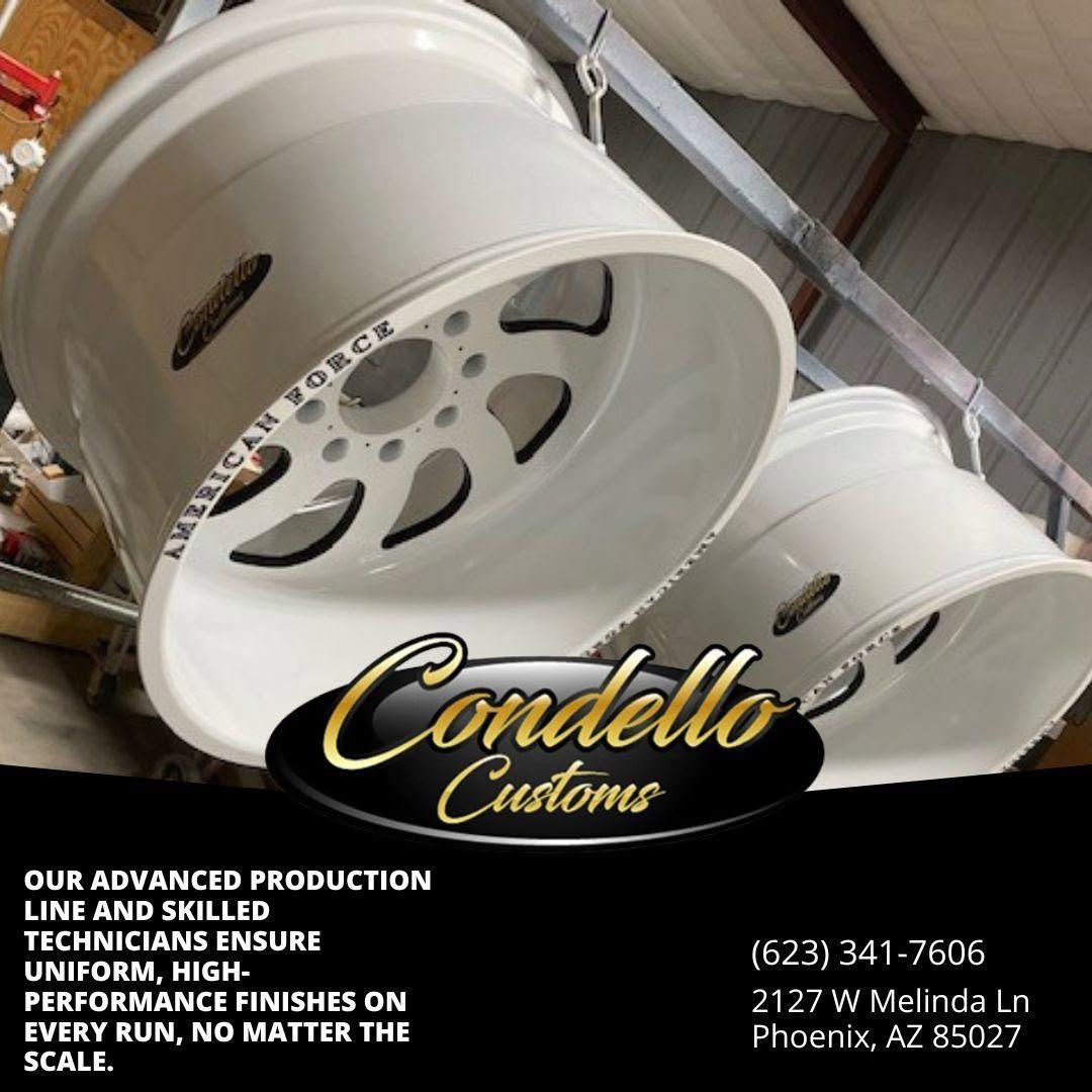Custom white alloy wheels in workshop