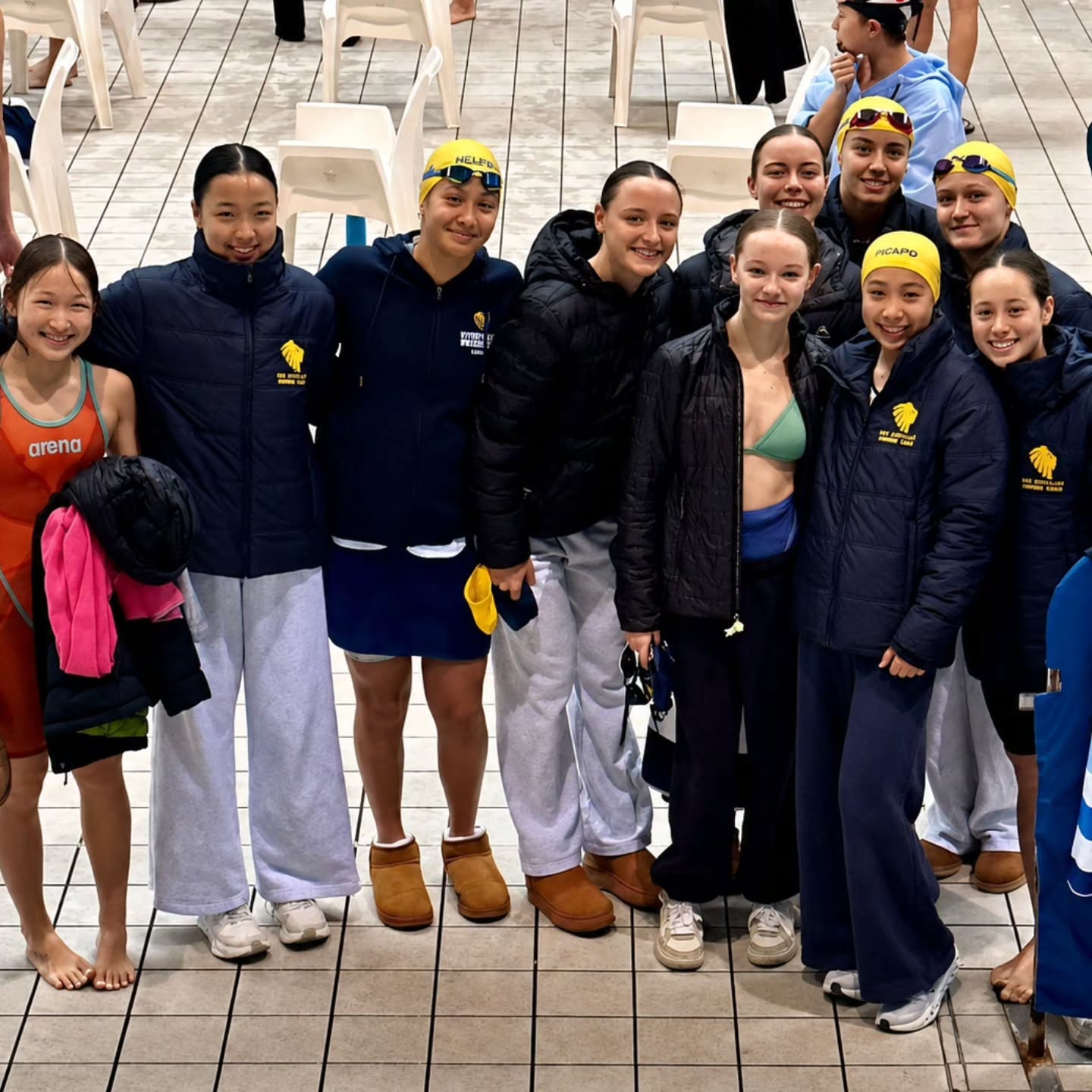 Sydney University Swimming Club members gathered poolside at a competition