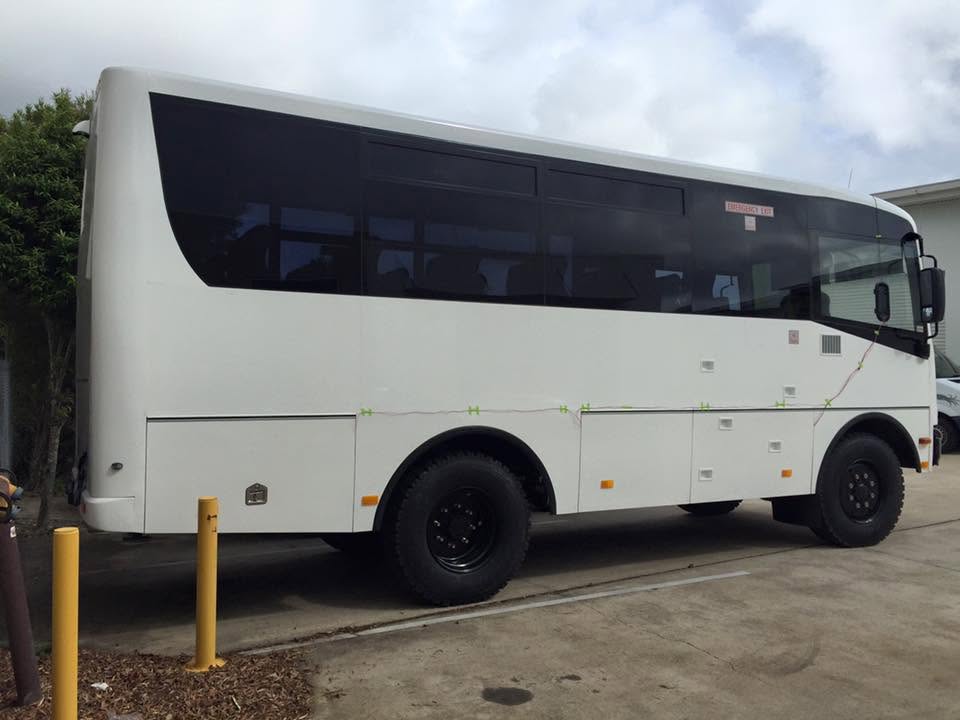 White commercial bus — commercial vehicle modification and fleet conversion example