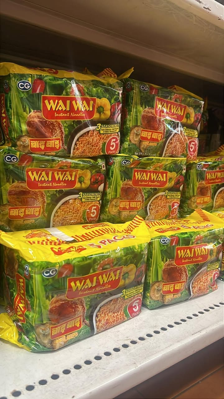 Wai Wai instant noodle multi-packs stacked on a store shelf at Nepalese Indo Bazaar