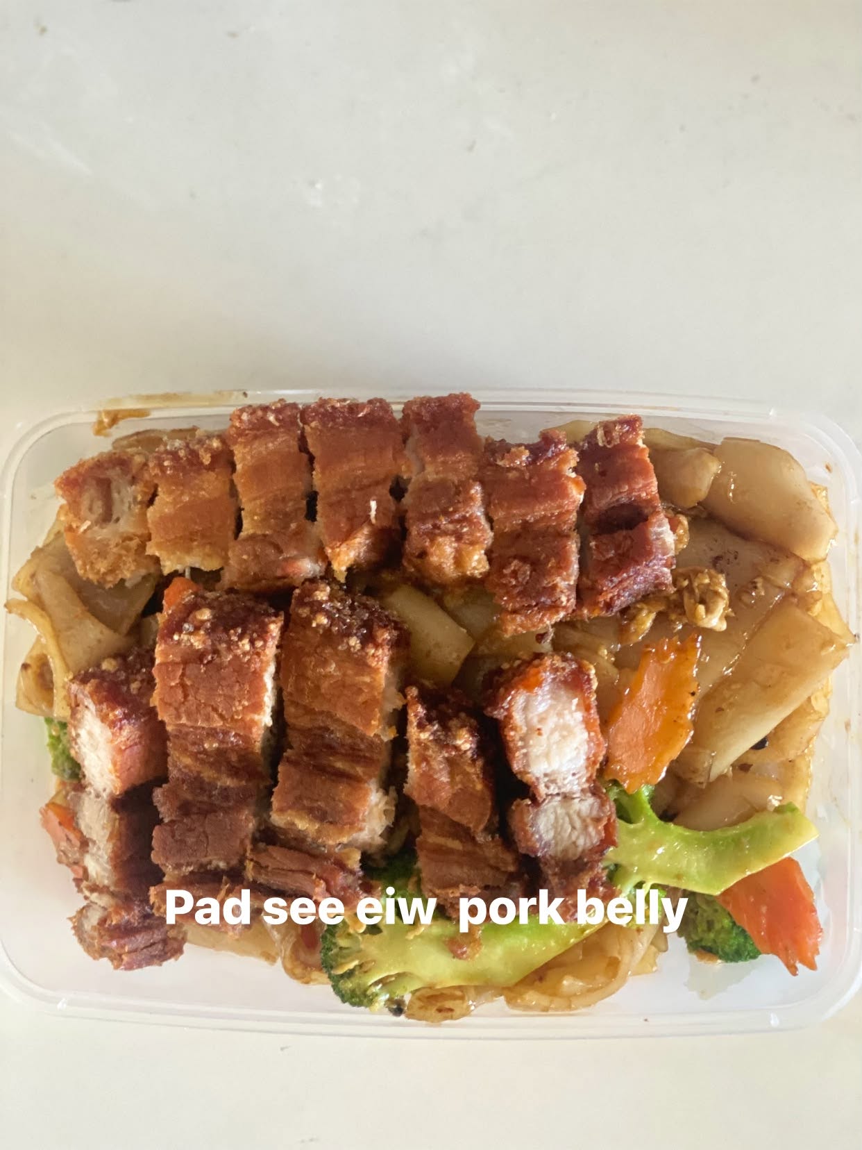 Pad see ew style noodle dish with pork belly and vegetables