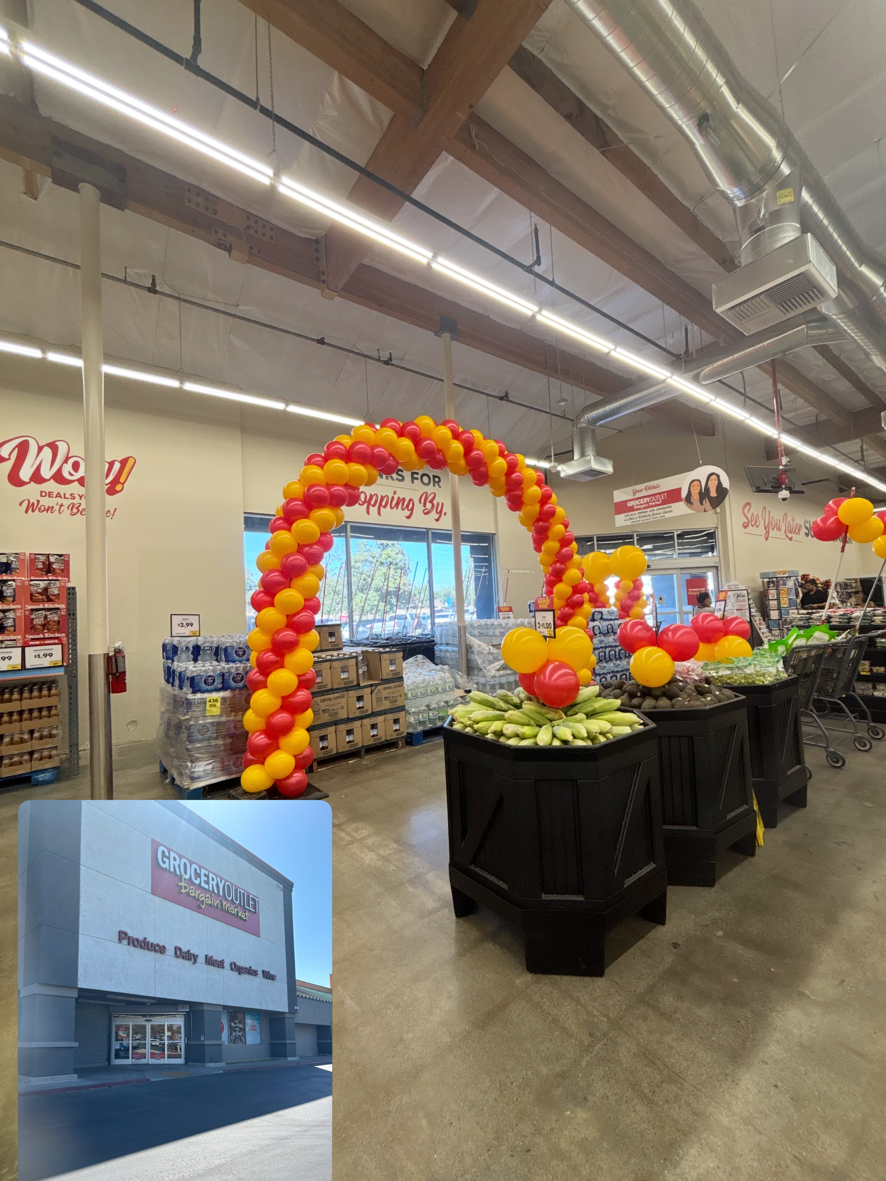 A red and gold balloon arch installed inside a retail store