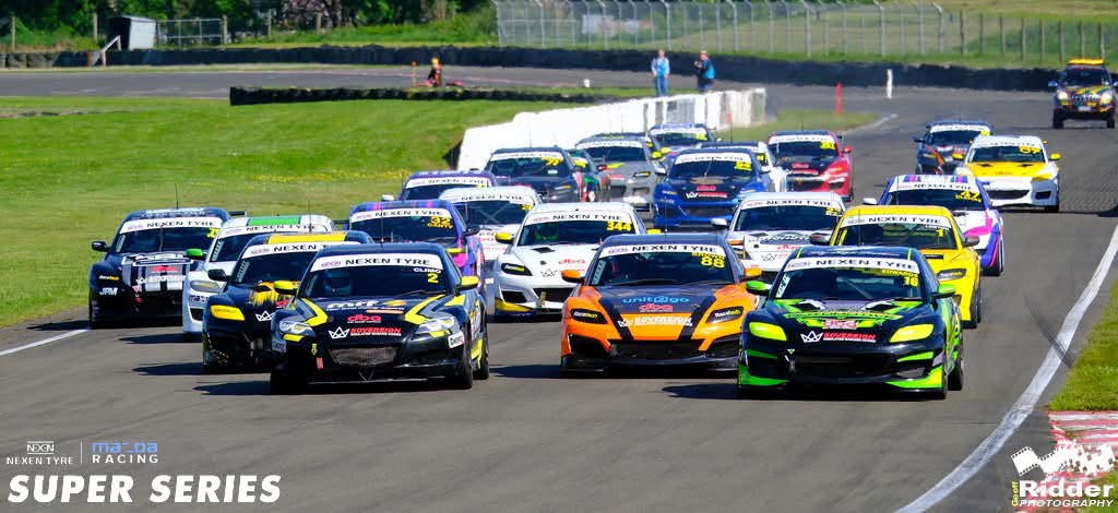 A pack of Mazda race cars on the starting straight