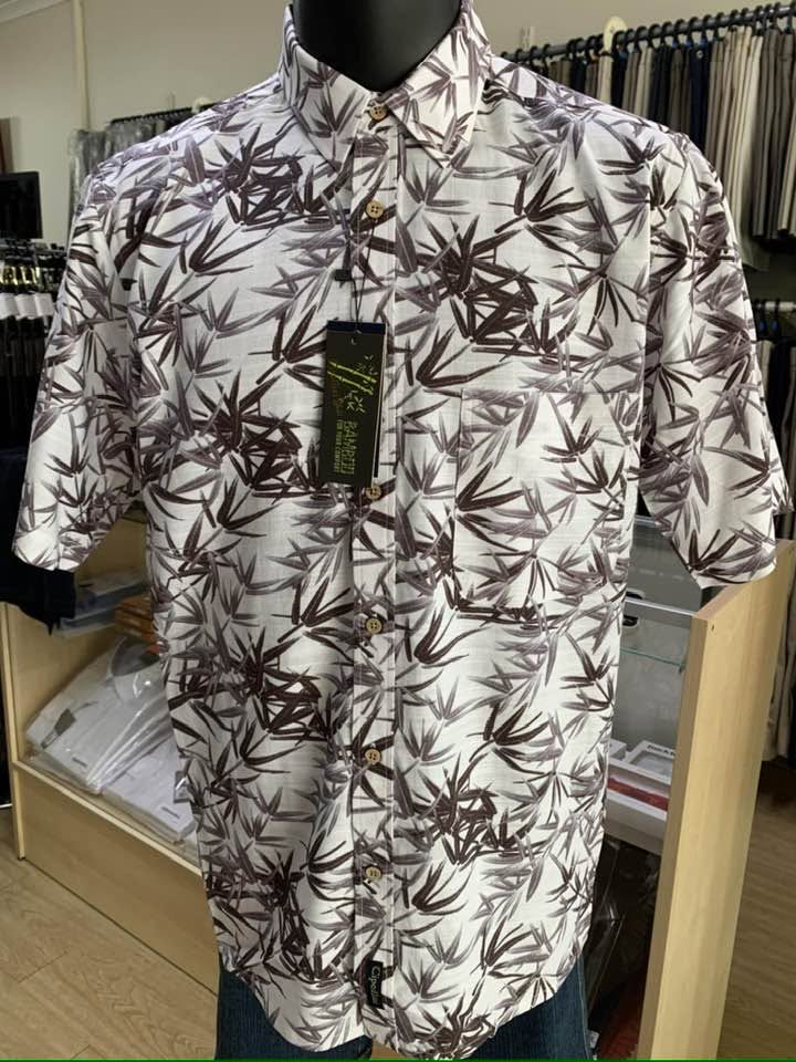 Short-sleeve shirt with a brown and white bamboo leaf print on a display mannequin