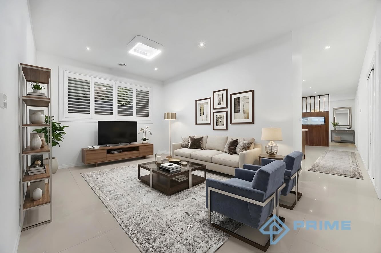 Elegant formal lounge with beige sofa and navy armchairs — premium property interior
