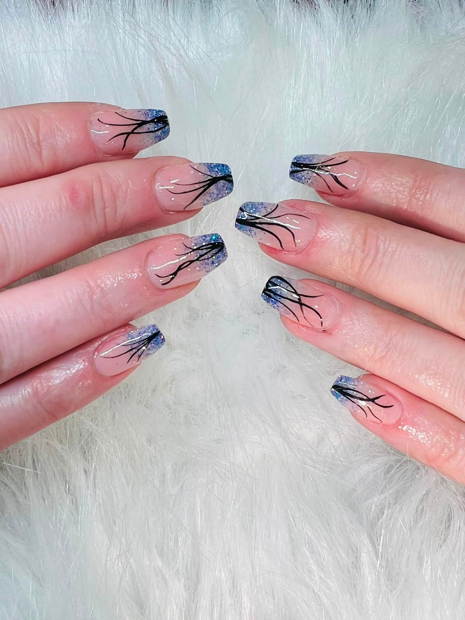 Glitter ombre nail art with fine line detailing