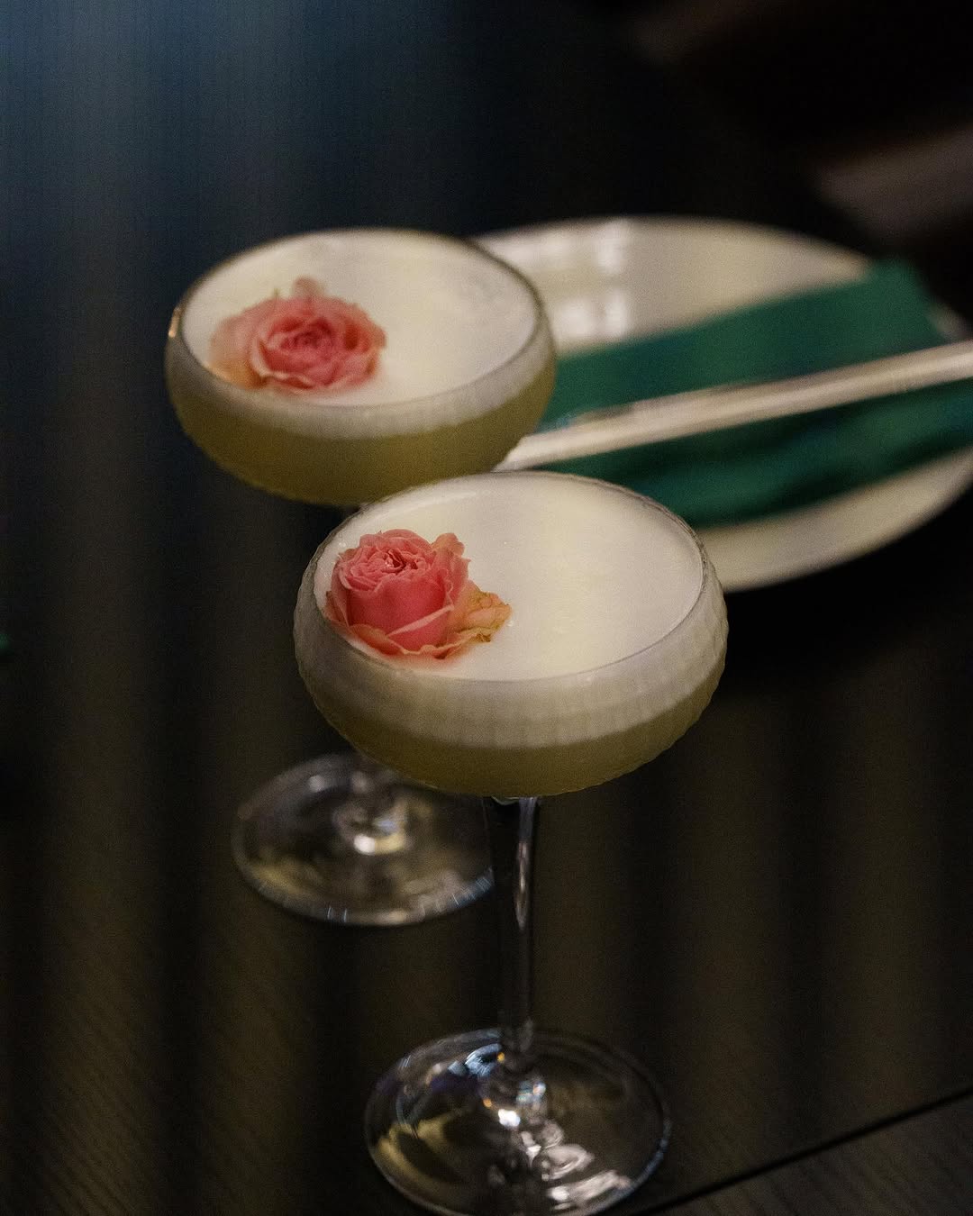 Elegant cocktail glasses with rose garnish — ambiance at Chef Chen Hawthorn