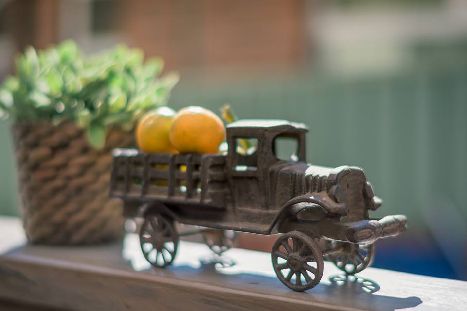 Vintage cast-iron toy truck decorative detail on a timber shelf at Monday Morning Cafe