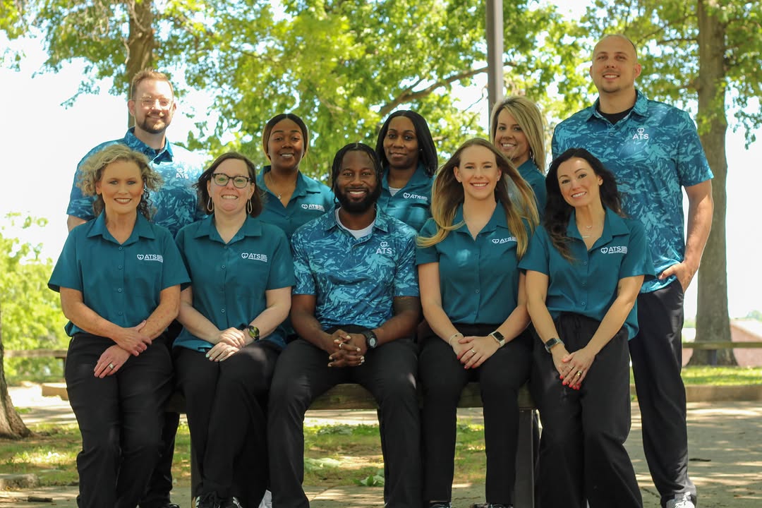 Professional Ahava Therapy Services team photo outdoors in matching teal ATS shirts