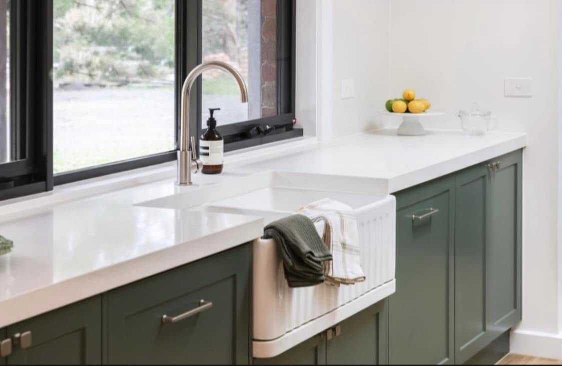 Spotless green-cabinetry kitchen ready for property inspection
