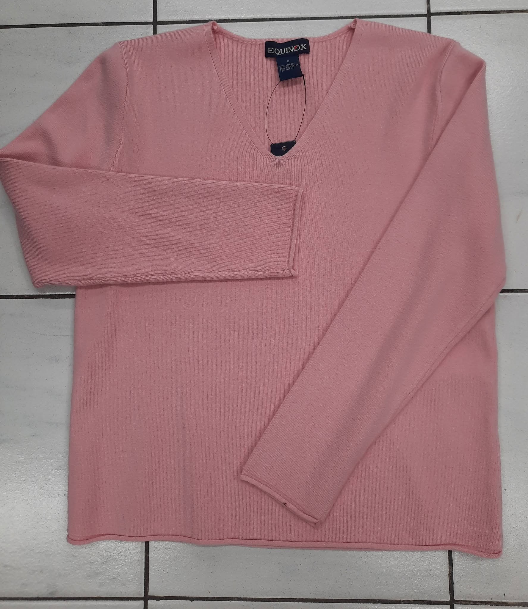 Dusty pink cable-knit vest laid flat