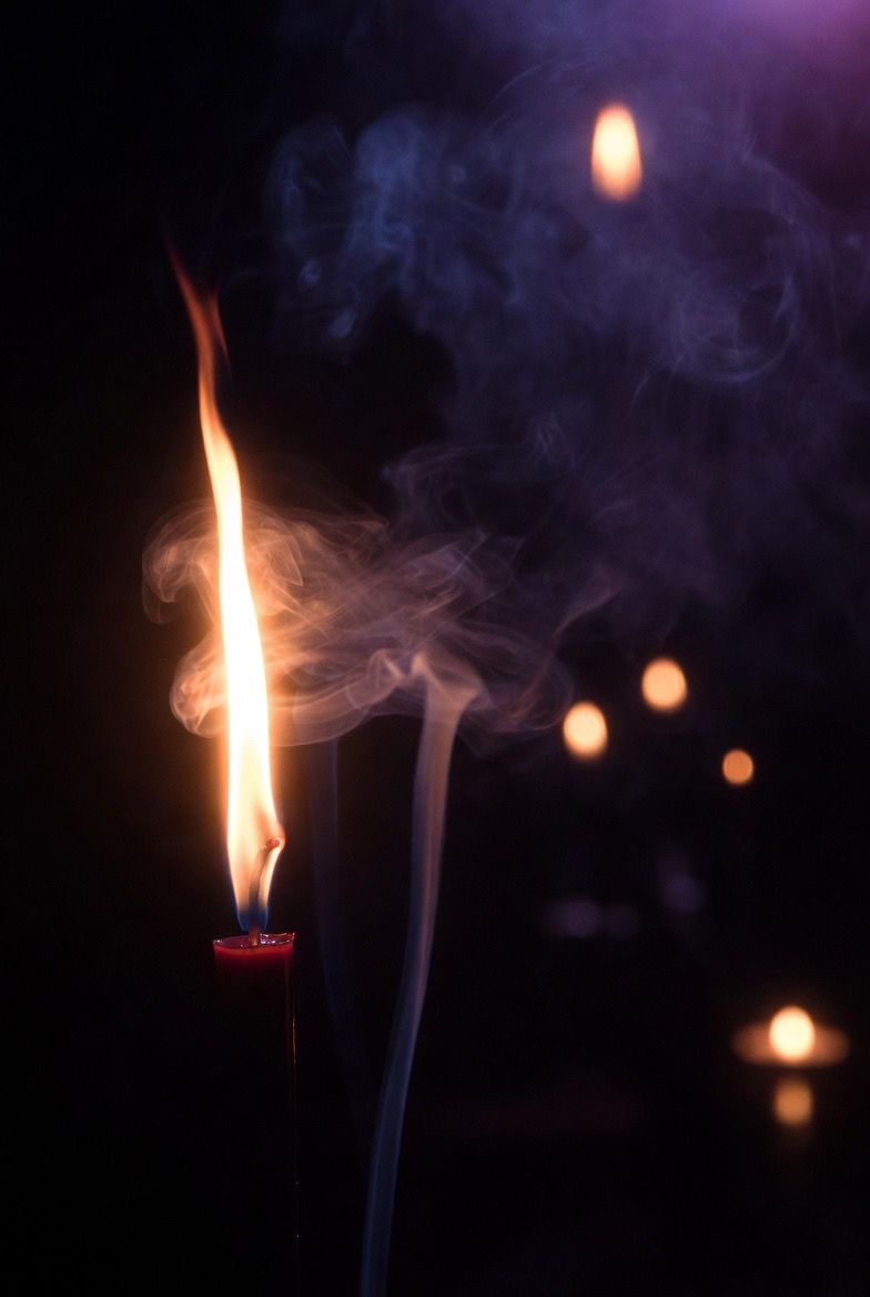 Mystical glowing hands with spiritual energy and purple smoke surrounding them