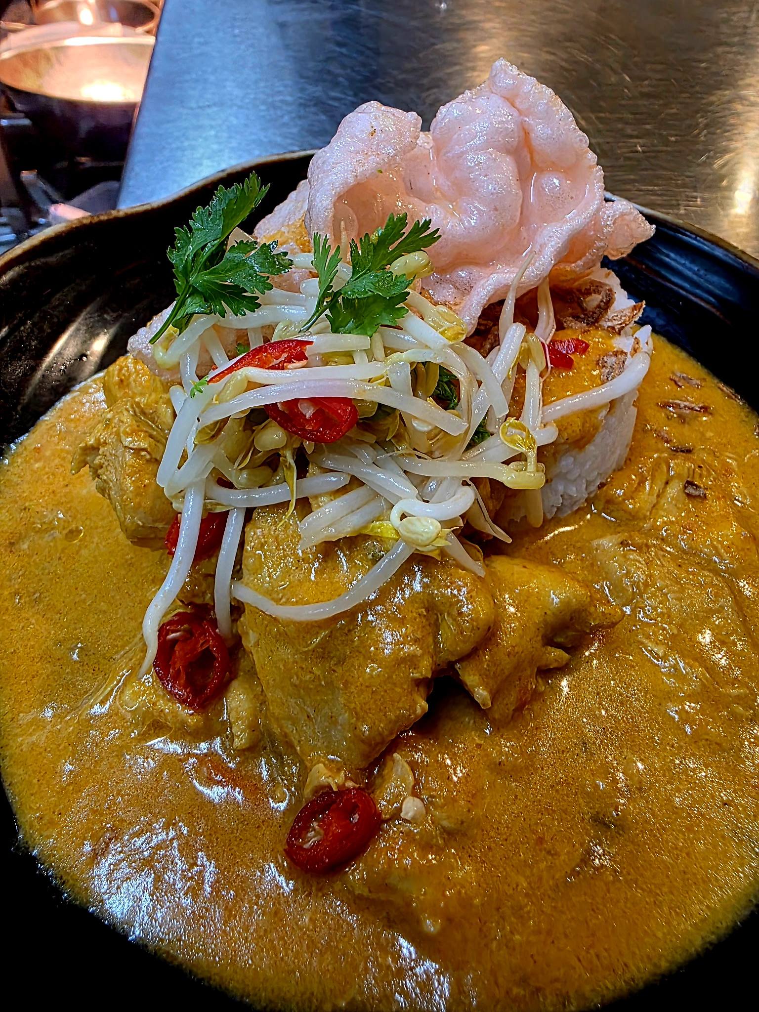 Flavourful curry with rice and bean sprouts at The Yardz Hotel