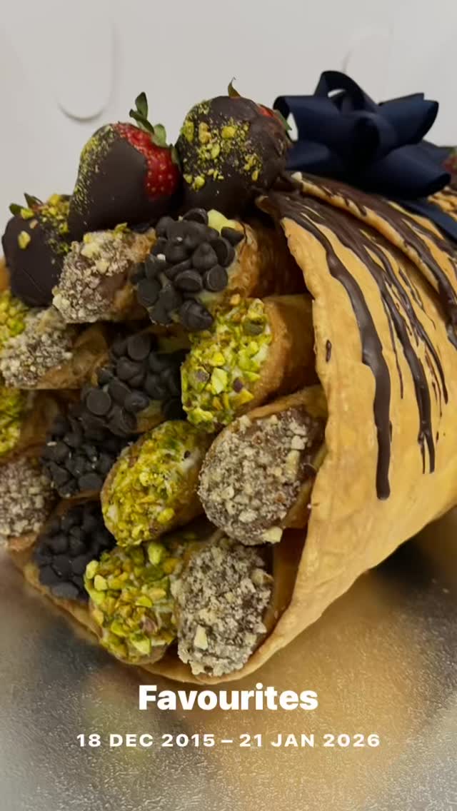 Casa Del Cannoli display case showing boxed assortments of fresh cannoli with custard and chocolate fillings