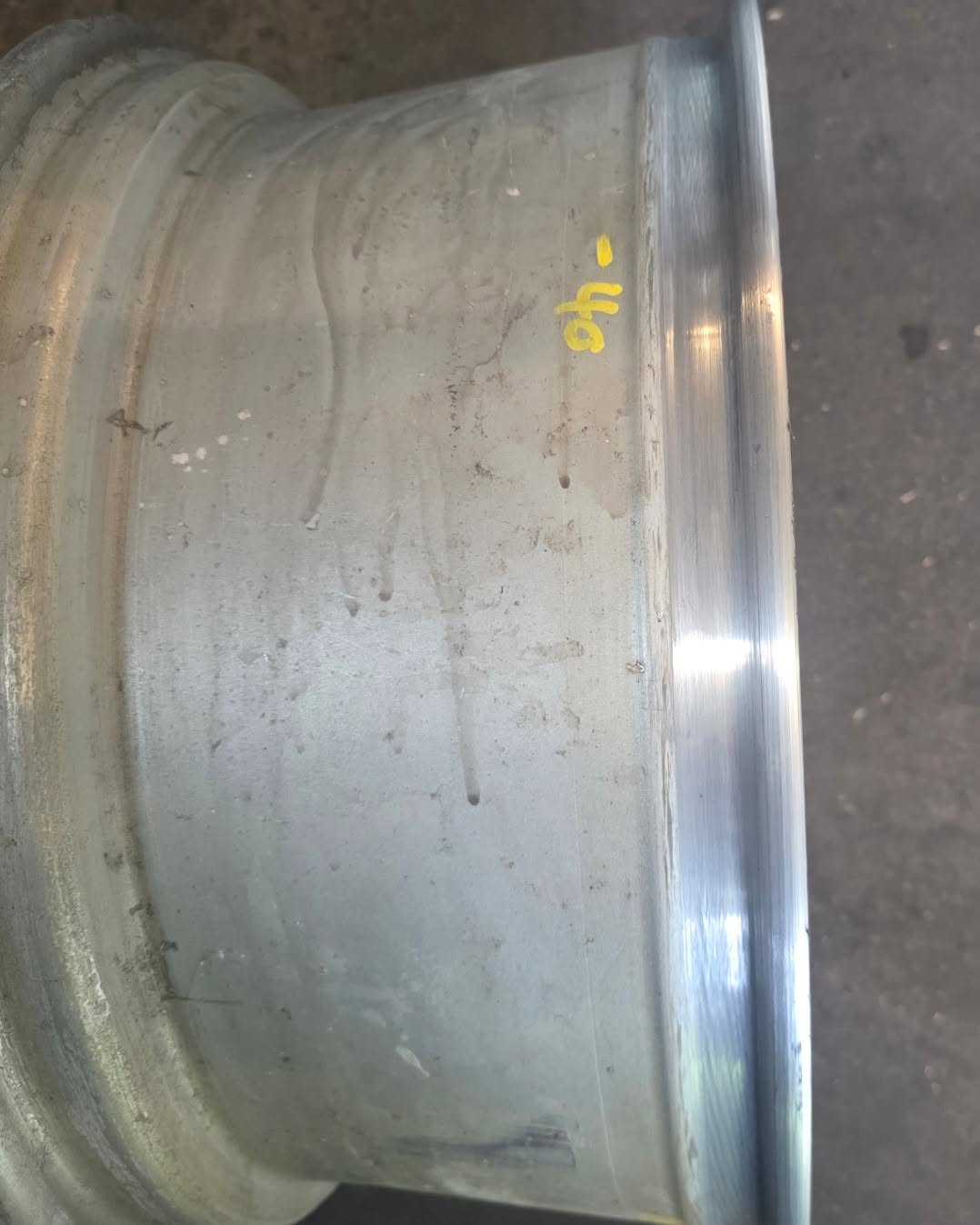 Alloy wheel barrel with surface scratches and oxidation marks