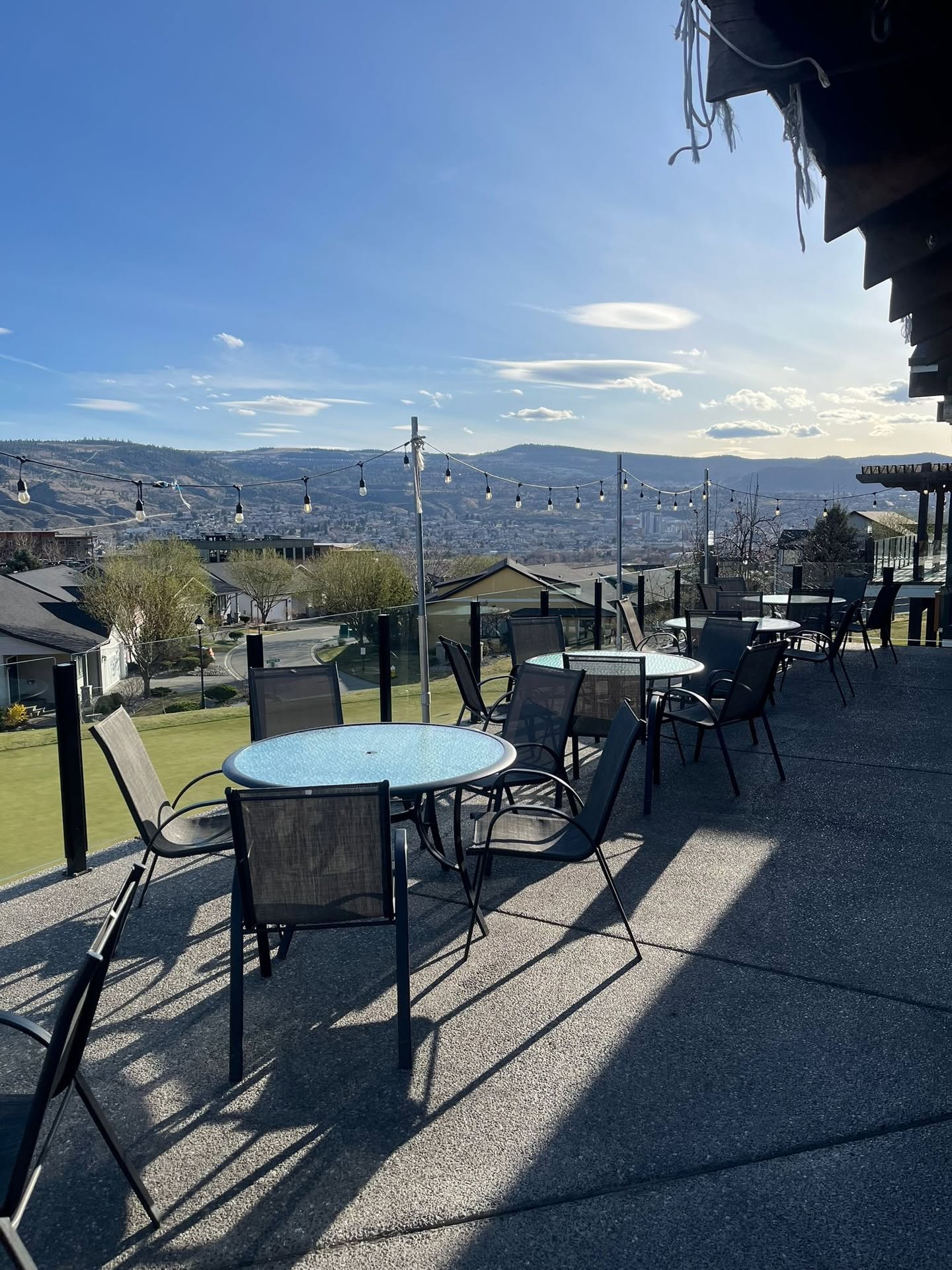 Outdoor terrace at Mason's Kitchen with Edison string lights and panoramic mountain and city views