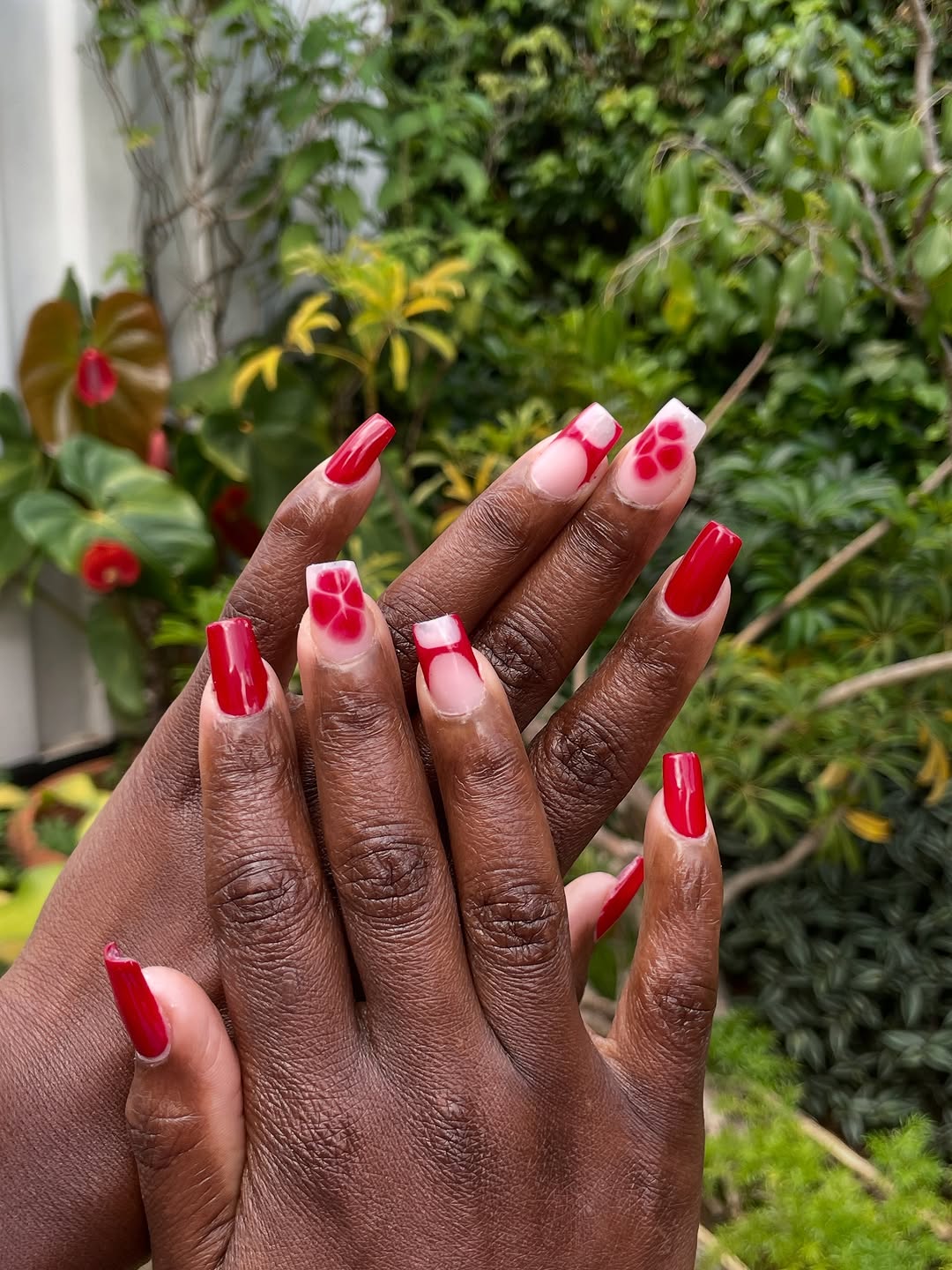 Red floral nail art on square long nails