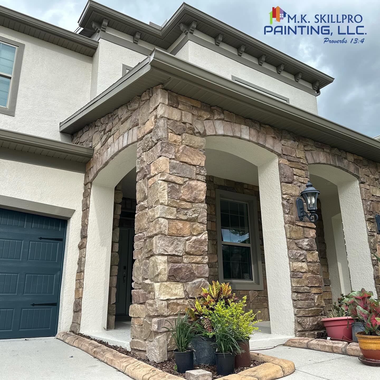Stone and stucco home exterior professionally painted by SkillPro Painting