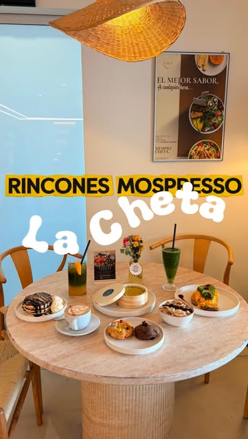 A cafe table at Mospresso with a spread of coffee, pastries and brunch dishes