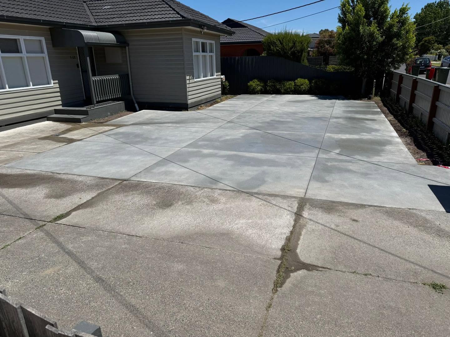 Wide plain concrete driveway completed by Benjamin's Concreting