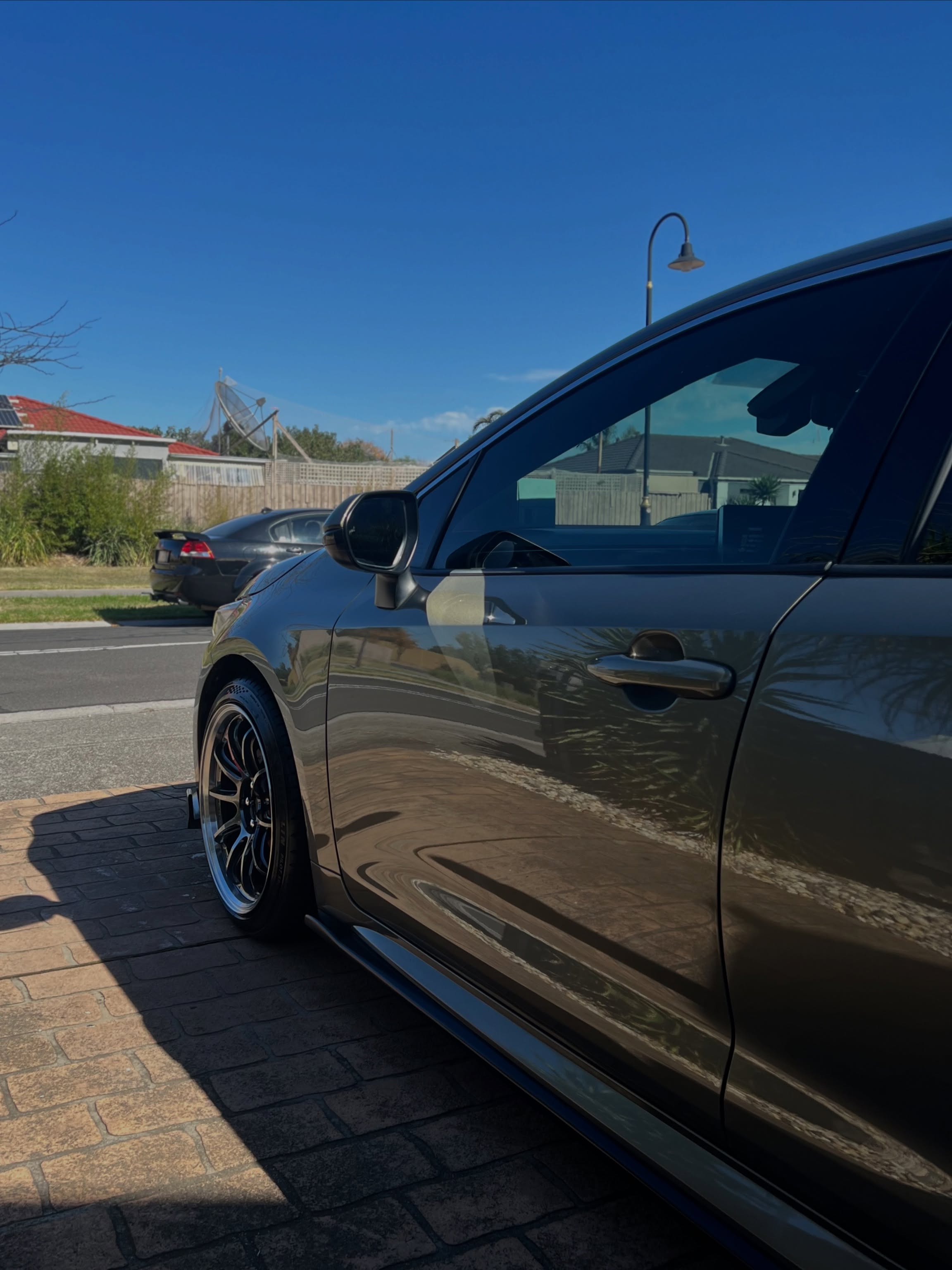 Freshly detailed car with a mirror-gloss finish parked in bright sunlight