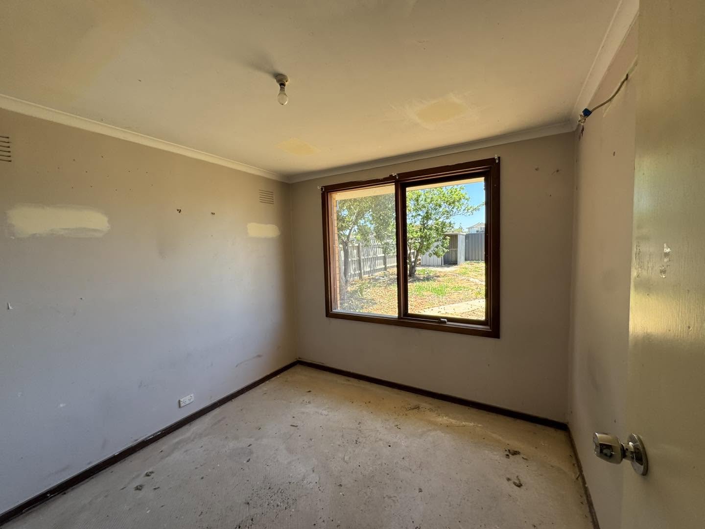 Interior room corner showing smooth plaster wall surface before painting