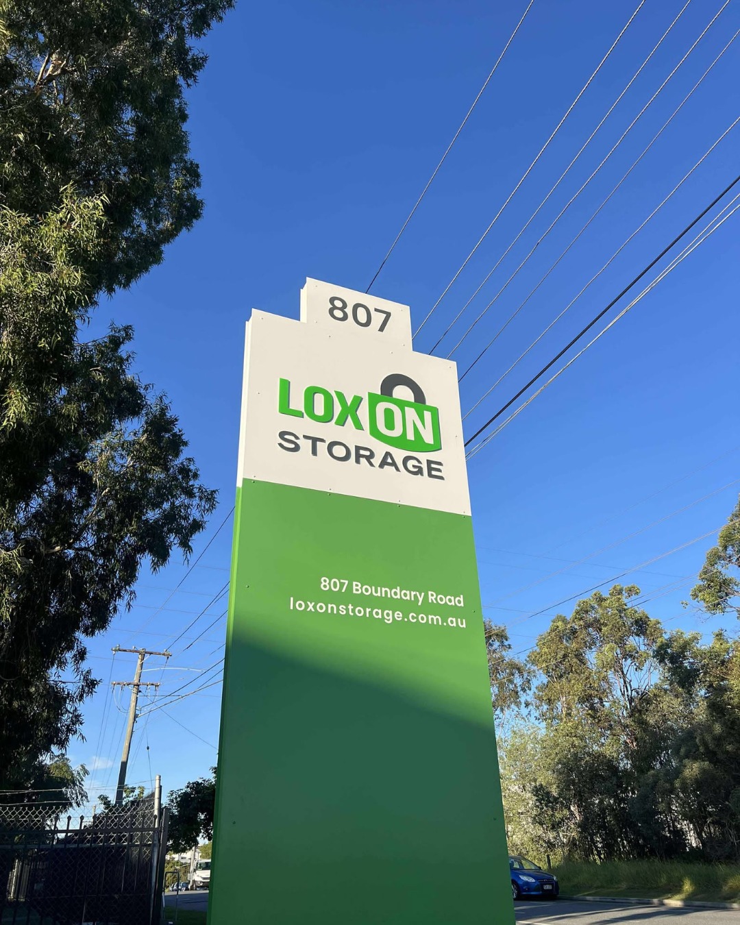 Loxon Storage pylon sign at 807 Boundary Road against a bright blue Queensland sky