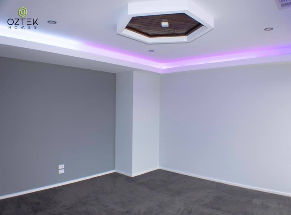 Entertainment room with hexagonal timber ceiling feature and LED strip lighting
