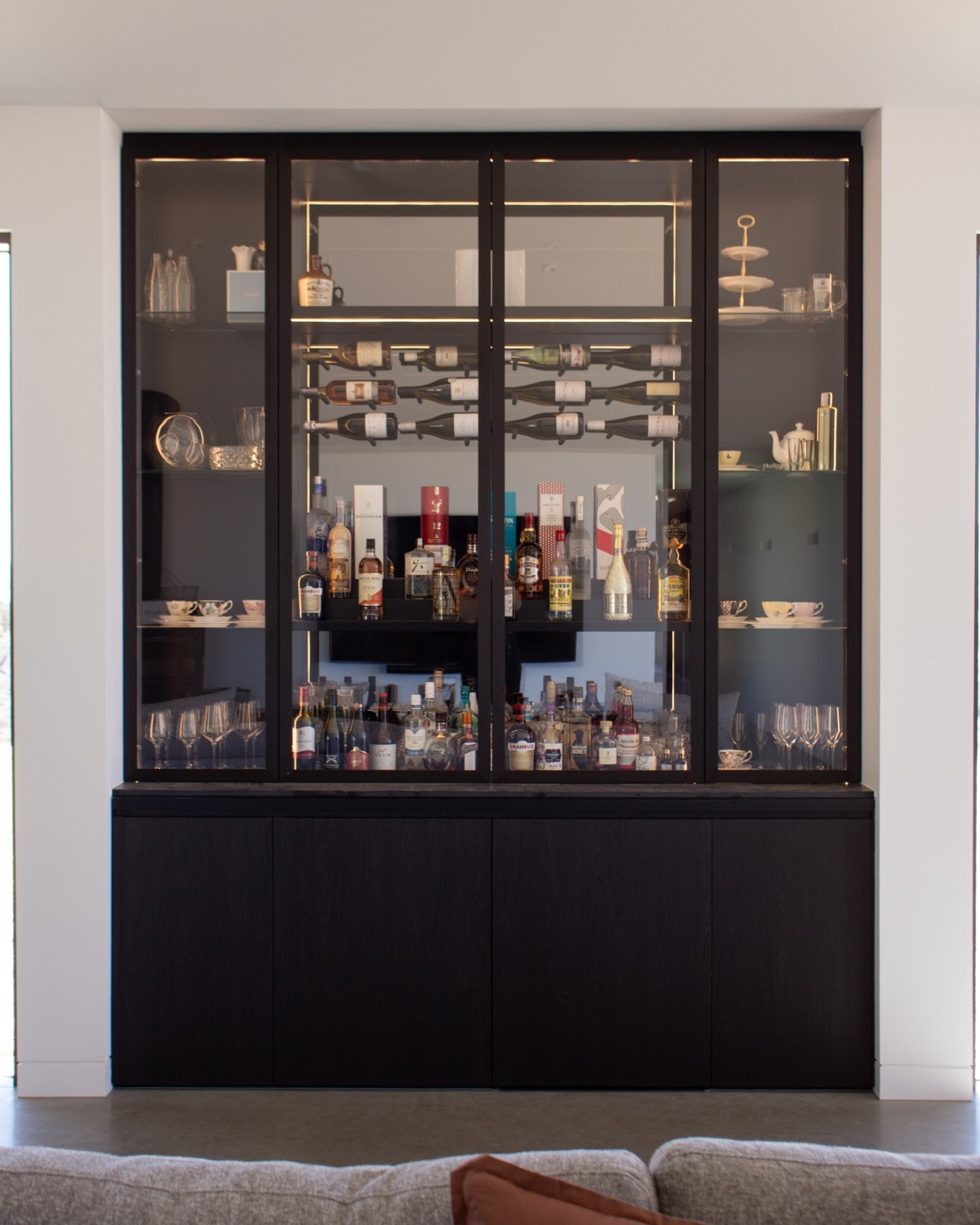 Custom built-in joinery cabinet with glass display doors, crafted by CABTEK