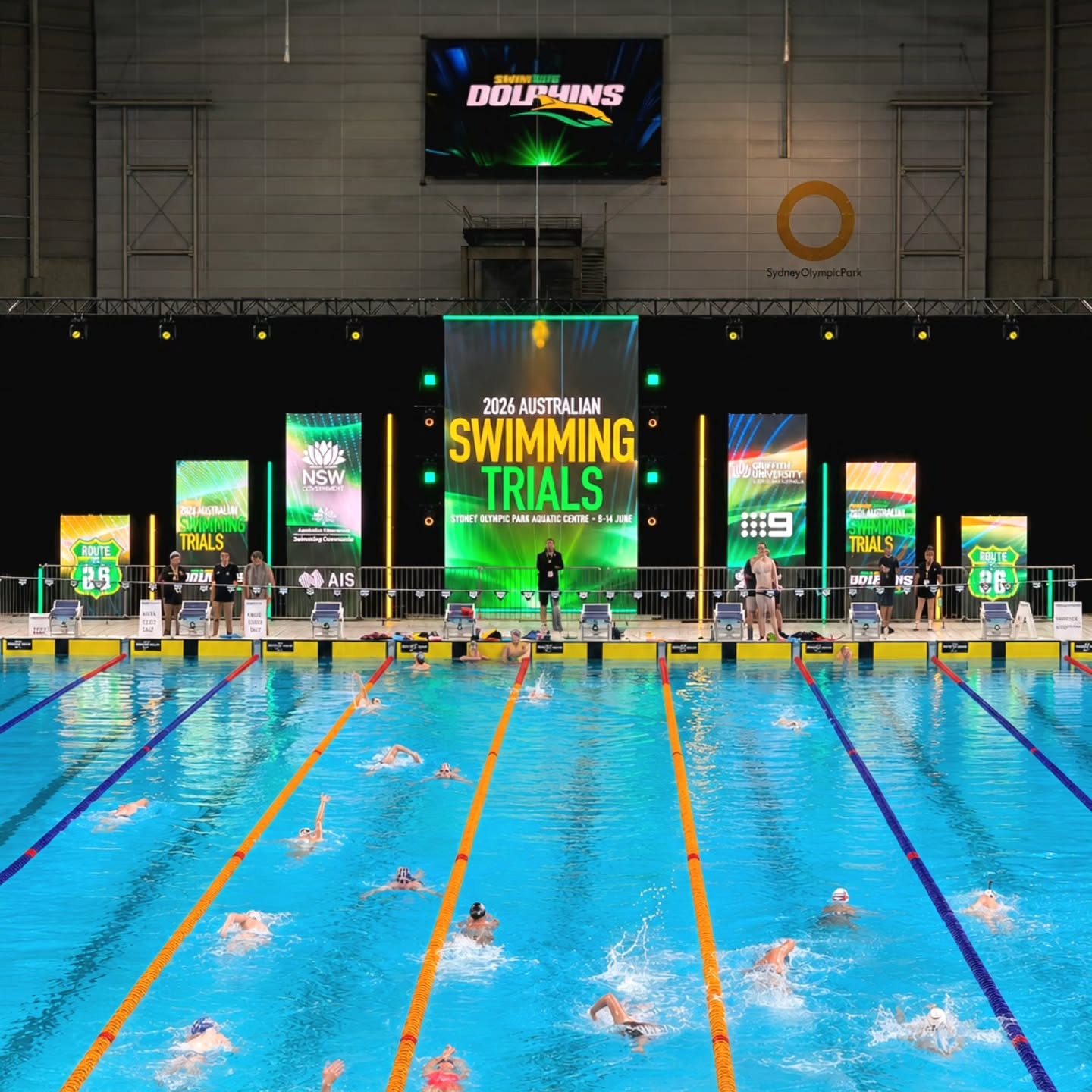 Aerial view of a competitive swimming pool with multiple swimmers in lanes
