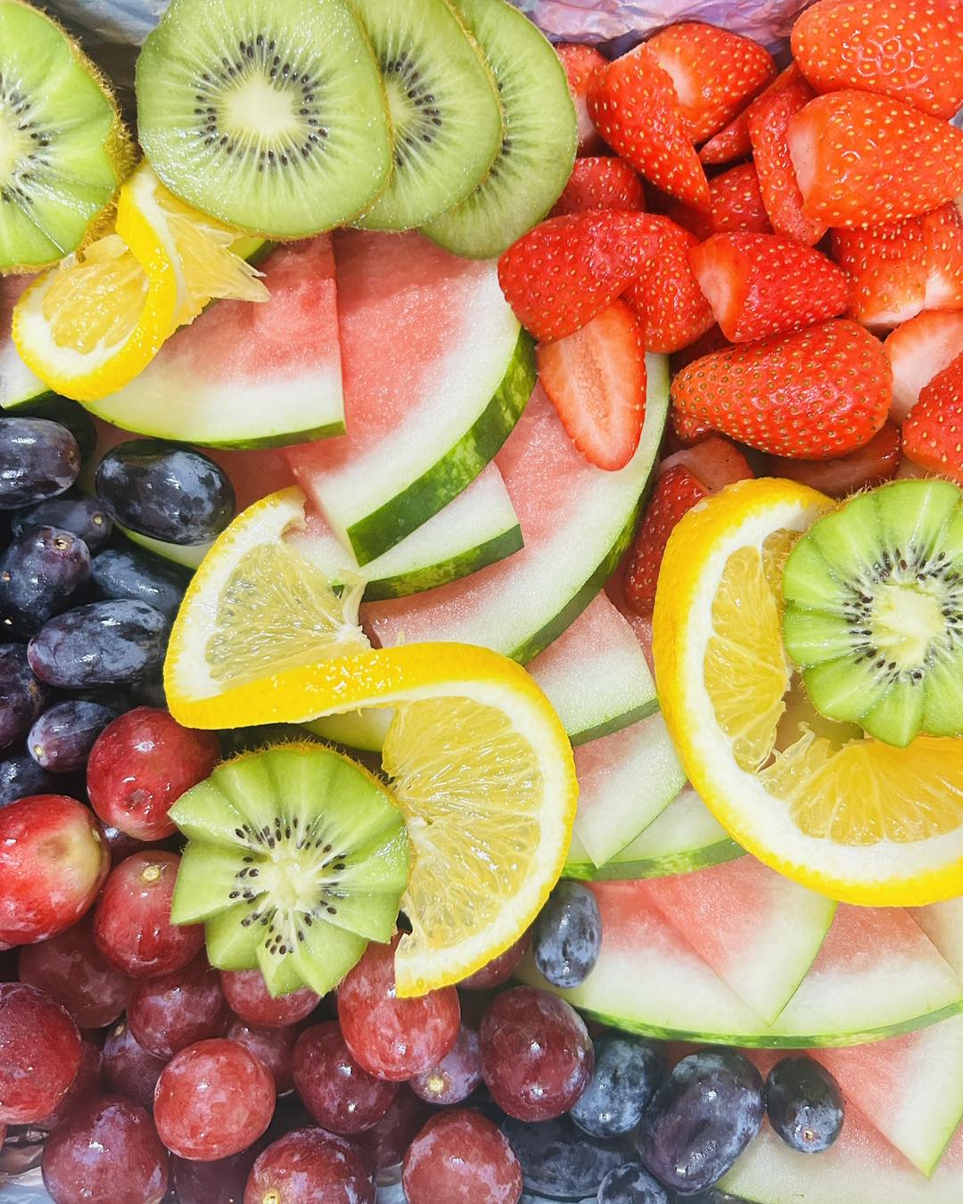 Fresh colourful fruit platter with watermelon, strawberries, kiwi and grapes