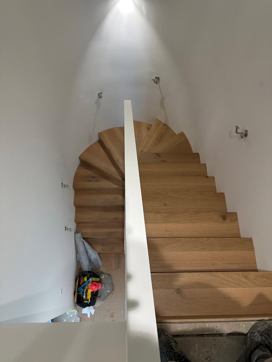 Oak timber spiral staircase treads viewed from above showing warm natural grain