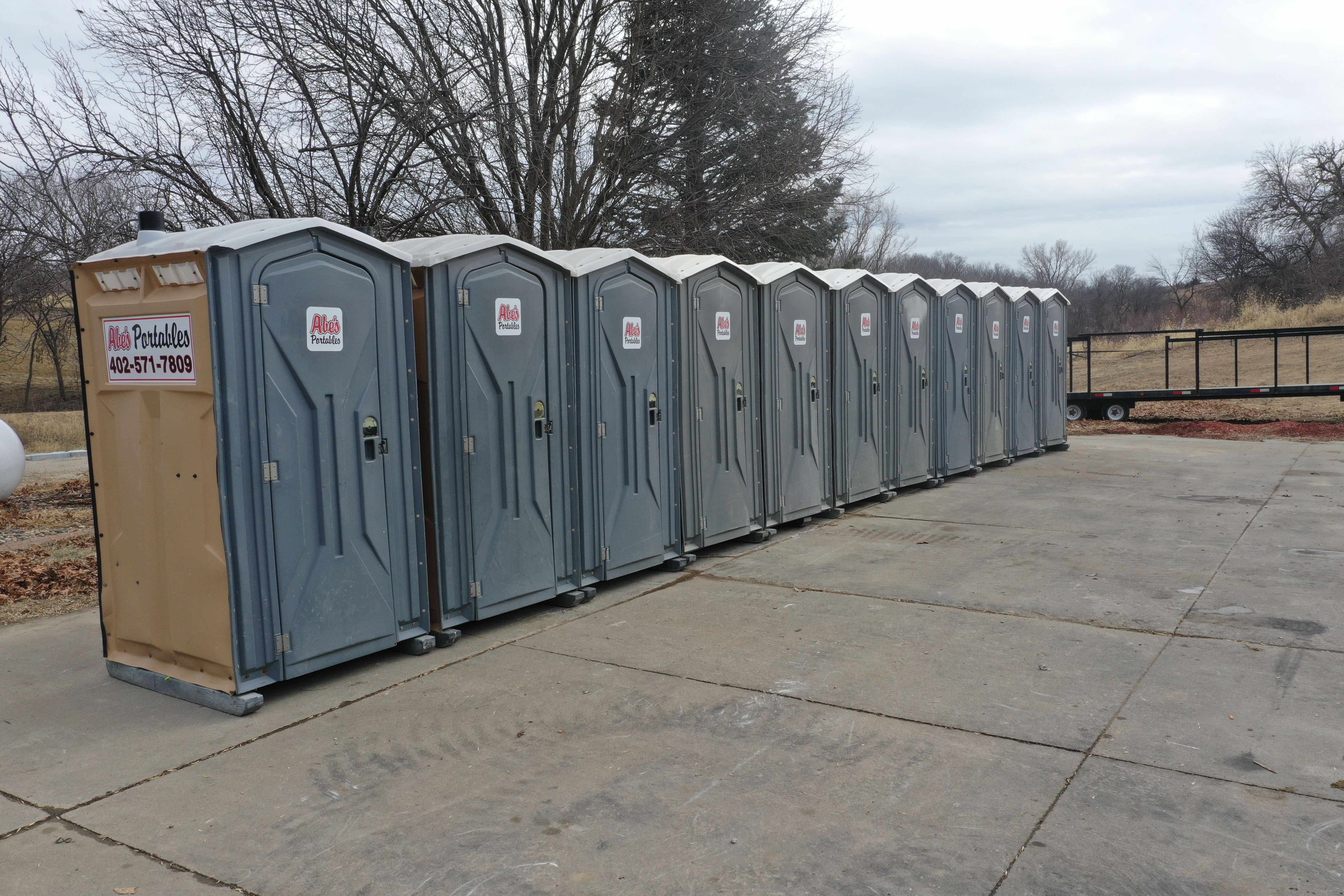 Row of Abe's Portables units on a concrete pad ready for a job site