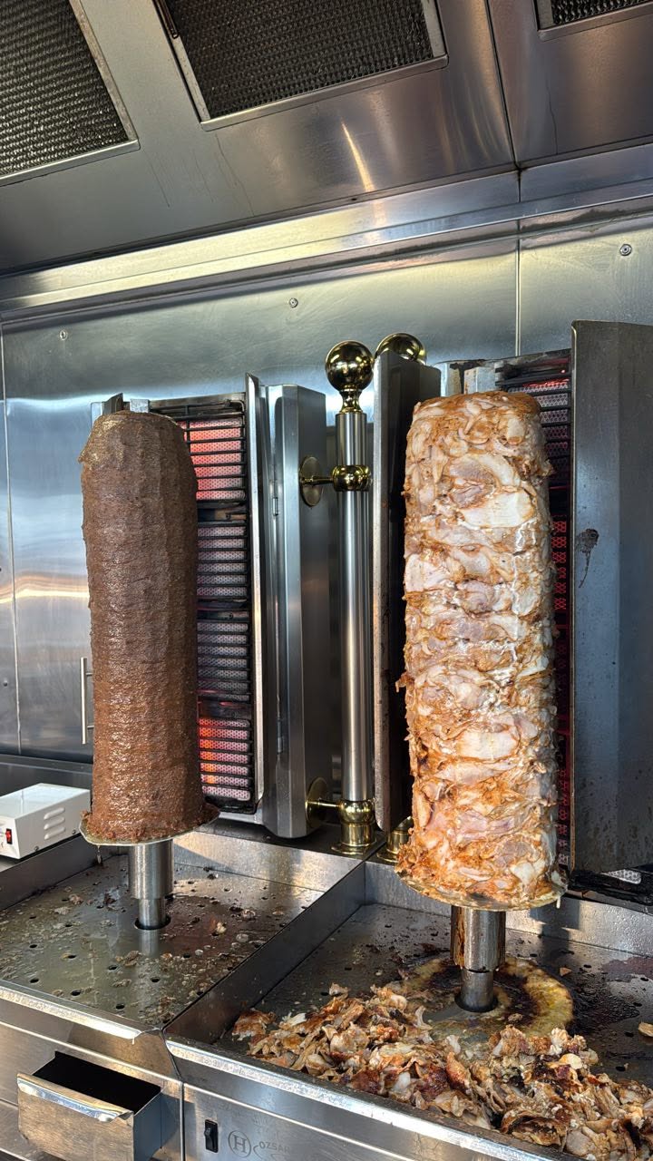 Freshly roasted kebab meat on a vertical spit at Nargis Indian & Kebab