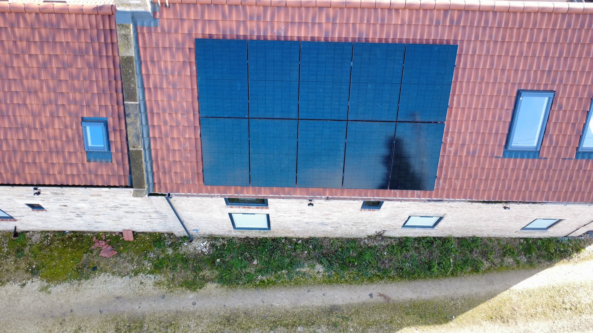 Aerial view of a solar panel array installed on a tiled roof
