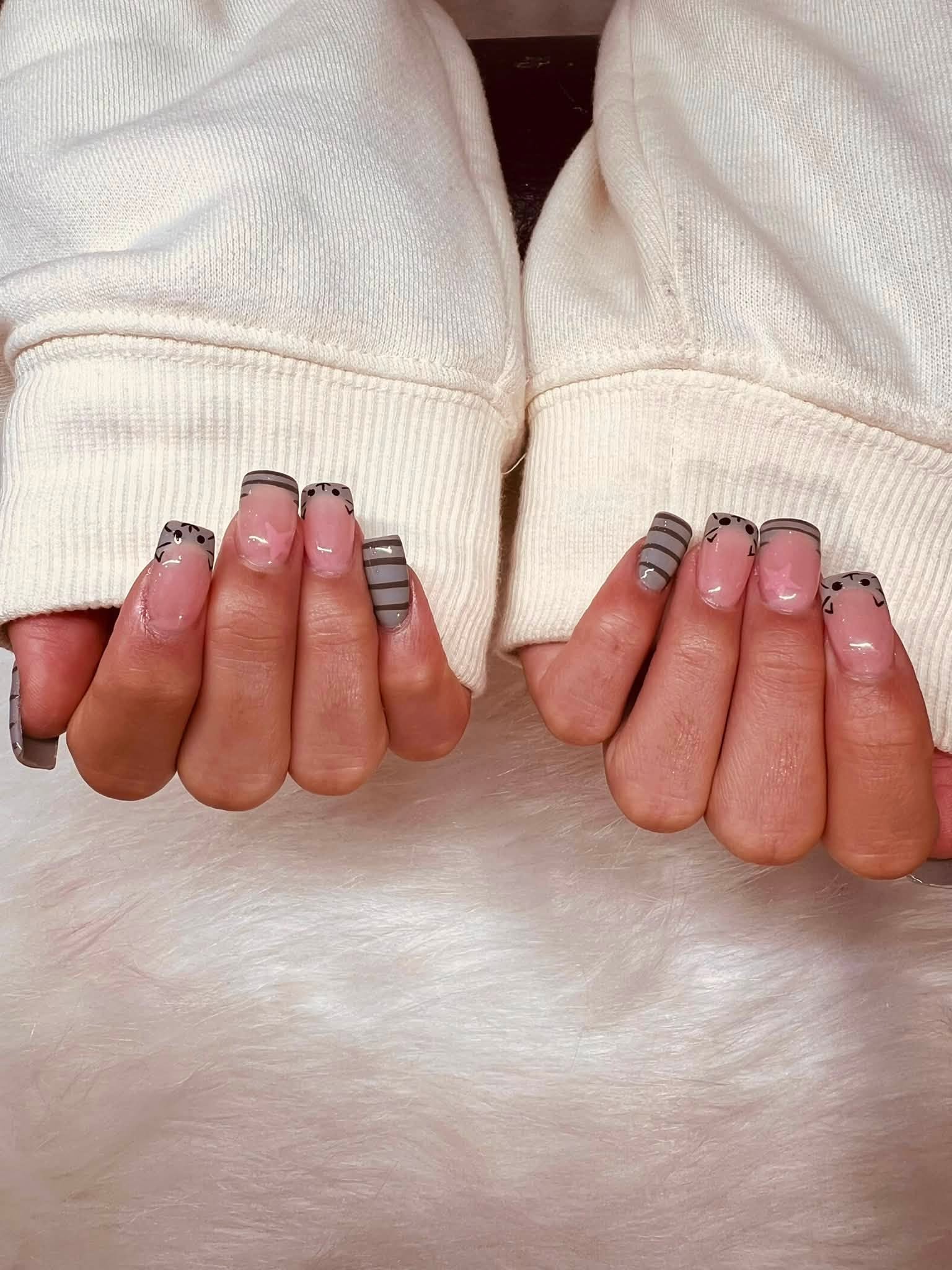 Grey striped nail art with cat face and star details