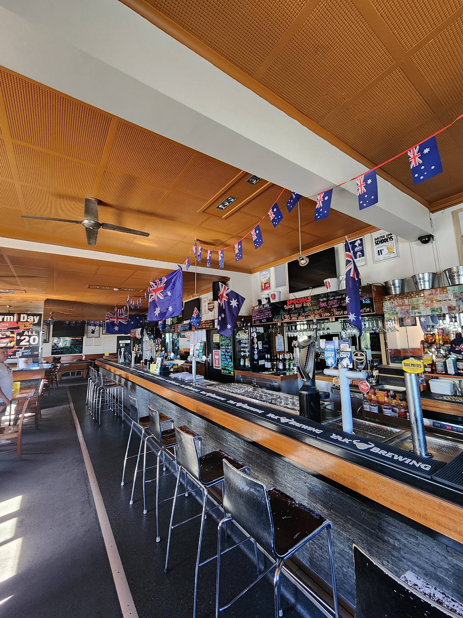 The Yardz Hotel main bar with timber accents and Australian flags