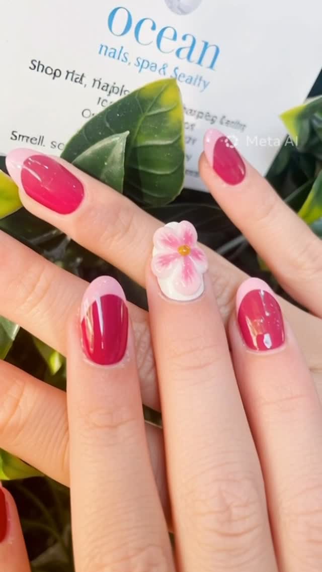 Crimson gel nails with 3D white floral accent