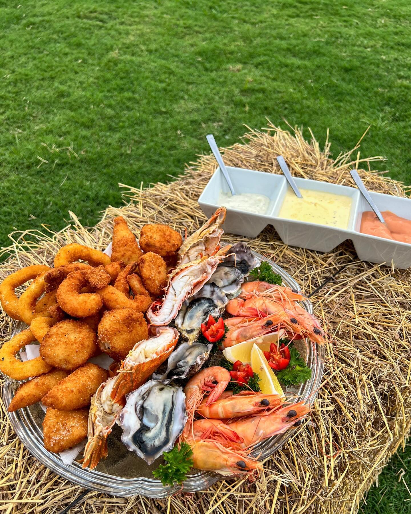 Fresh seafood platter with calamari, oysters, prawns and dipping sauces served at the Yandaran Hotel beer garden
