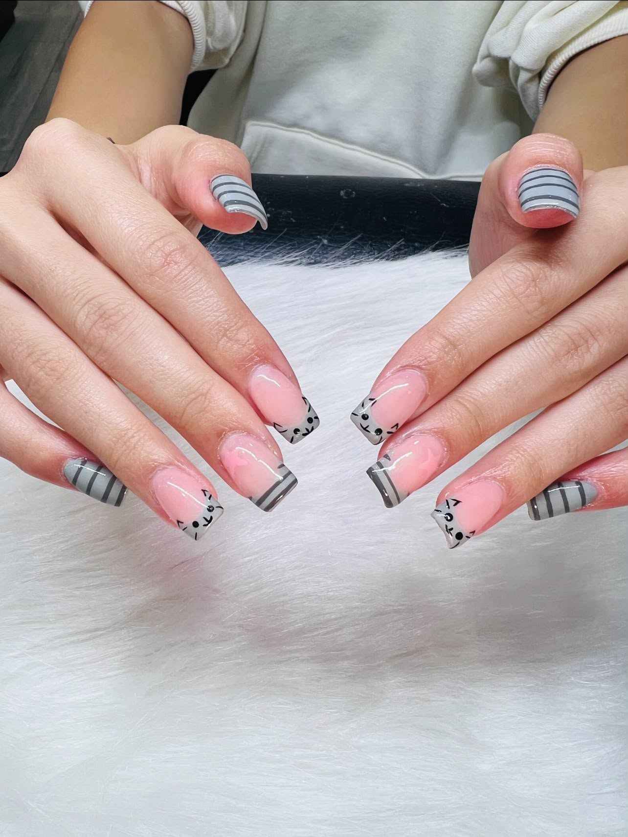 Grey striped nail art with cat face design