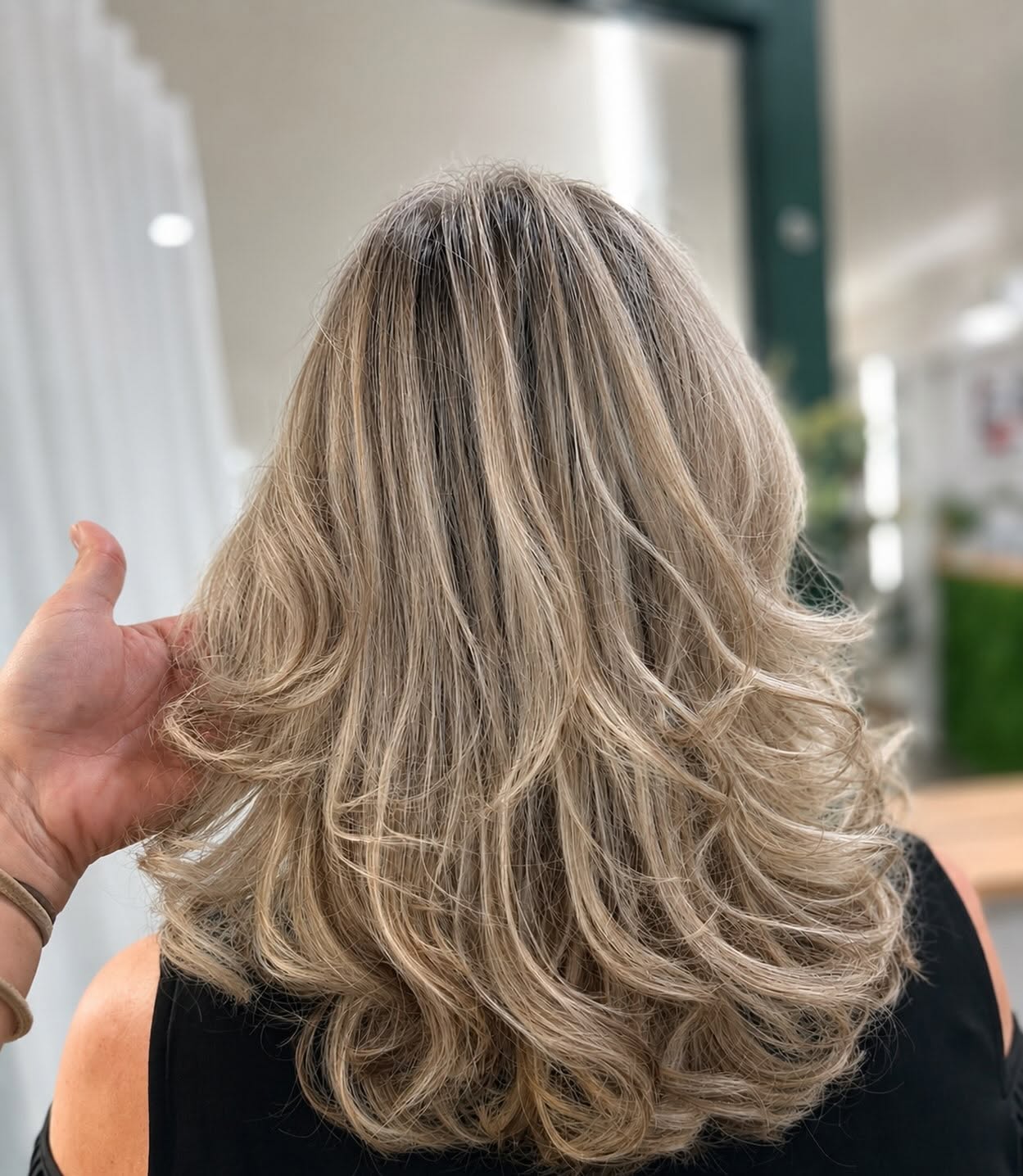 Soft, blonde balayage waves styled at Opal Hair salon