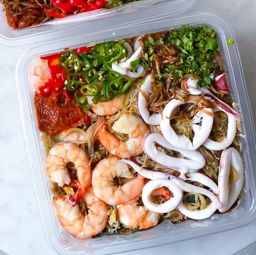 Hokkien Mee takeaway platter with prawns, squid rings, sambal, and fresh herbs