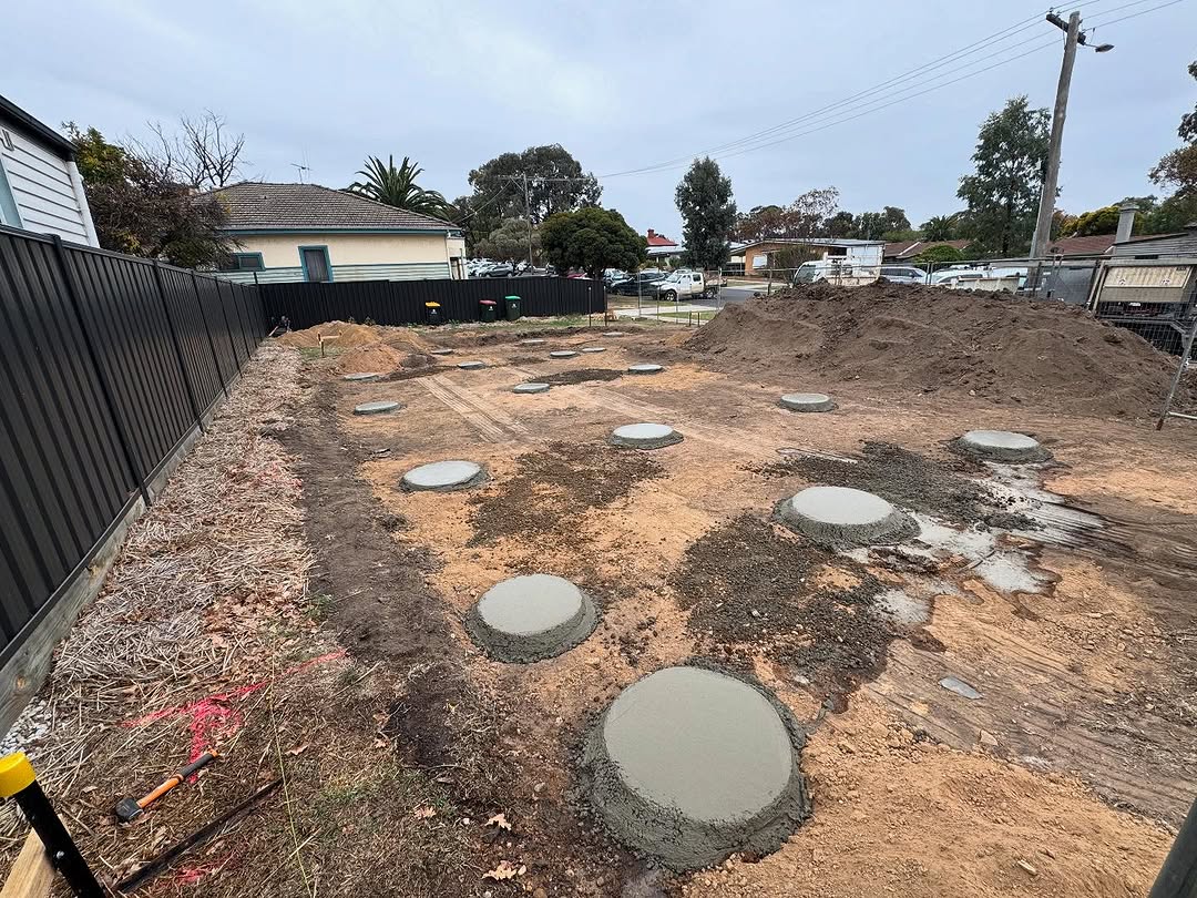 Concrete pier footings laid out on a prepared building site