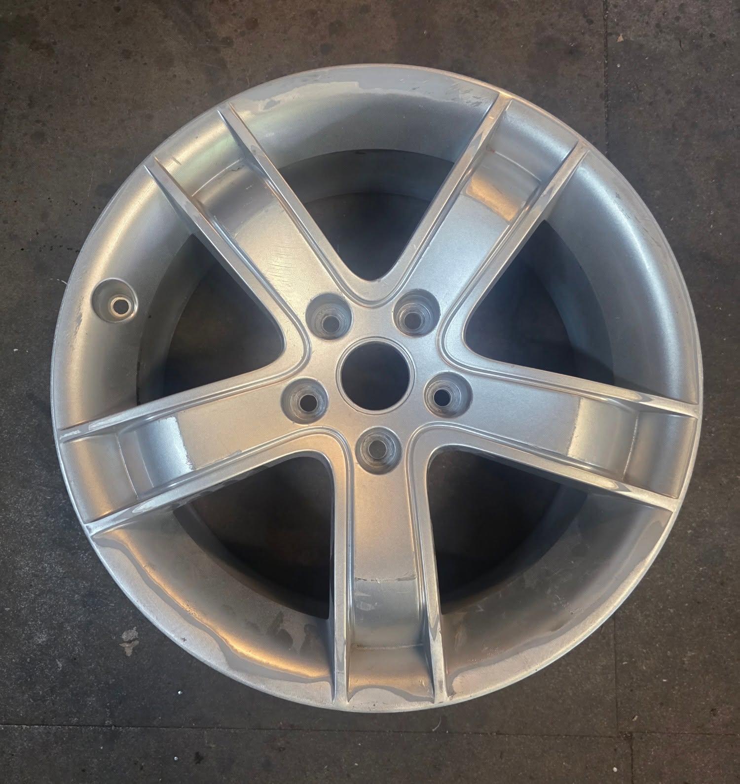 Freshly refurbished 5-spoke alloy wheel with clean silver finish