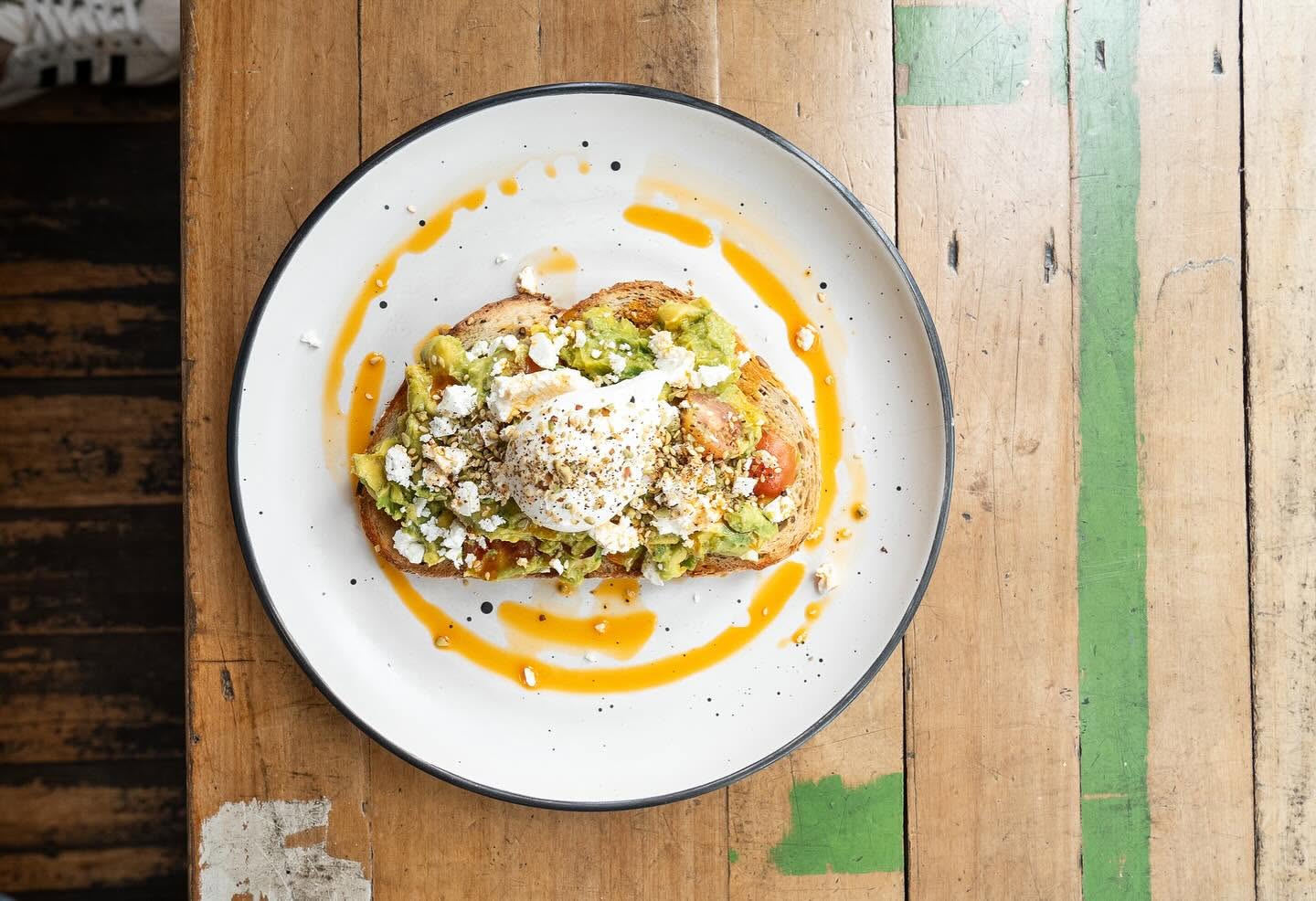 Poached egg and avocado toast with feta at Milking It